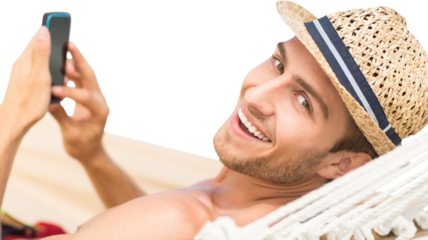 Digital png photo of smiling caucasian man in hammock using smartphone on transparent background