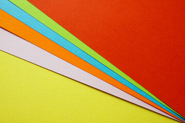 Sheets of colored paper as a concept of creativity and diversity. Modern colored background.