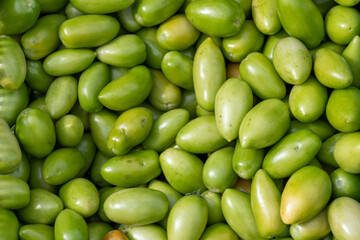 Green background from unripe tomatoes