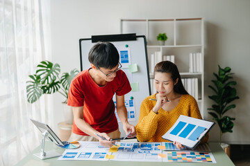  UX developer and ui designer brainstorming about mobile app interface wireframe design with...