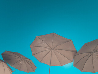 beach umbrellas against the background of a clear blue sky. vacation and beach holiday concept. soft focus.