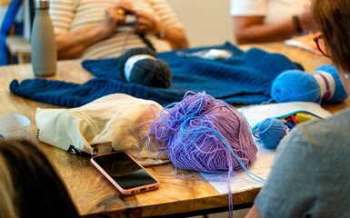 Crochet club. Elderly women knitting together in a workshop.