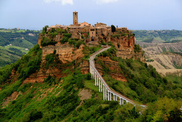 Panoramic view of the valley and town of Civita di Bagnoregio with stone houses on a high cliff in the province of Viterbo, Lazio region, Italy