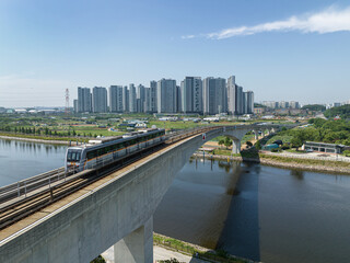 Monorail train on the railroad tracks in the city, aerial view