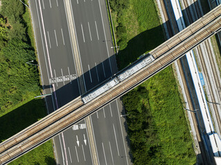 Monorail train on the railroad tracks in the city, aerial view