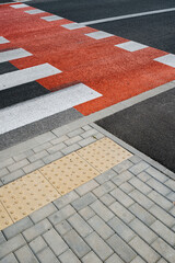 Pedestrian crossing with new white stripes on gray asphalt in city - obrazy, fototapety, plakaty