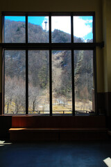 Scenery of the mountains in Japan Through the glass window view in the building of Shinhotaka Ropeway Station,  in Takayama City, Gifu, Japan