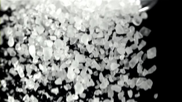 Falling Salt Crystals On A Black Background. Filmed On A High-speed Camera At 1000 Fps. High Quality FullHD Footage