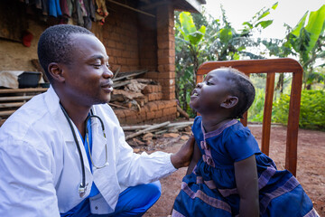 African doctor talking to a sick baby girl during a visit in a rural area in Africa - obrazy, fototapety, plakaty