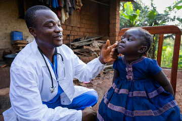 Black Pediatrician paying visit to an ill child in a rural area. Health concept