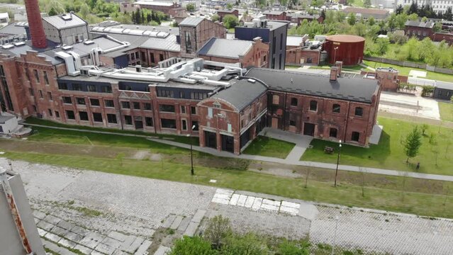 Aerial shot of the Żnin Arche Hotel inside old sugar factory in Poland. Pan and tilt-down shot.