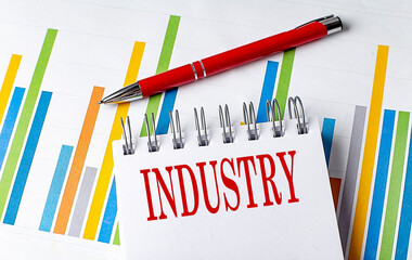 INDUSTRY text on a notebook with chart and pen business concept