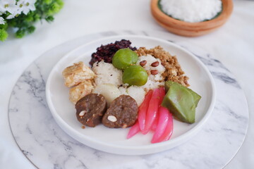 Jenang Madura is a typical Indonesian food that consists of black sticky rice, porridge marrow, jenang grendul and red pearls that were given palm sugar and coconut milk