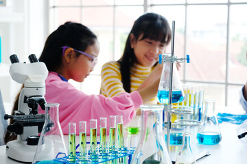 Girl doing science test in laboratory.