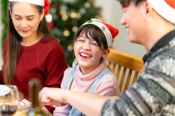 Merry Christmas and Happy New Year 2024!Multiracial young creative family are celebrating holiday.