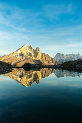Silhouette of Man, Mountains and Reflection in Lac Blanc Lake at Sunset. Golden Hour. French Alps, France