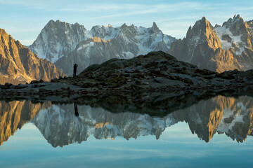 Photographer Man, Mountains and Reflection in Lac Blanc Lake at Sunset. Golden Hour. Chamonix, French Alps, France - obrazy, fototapety, plakaty