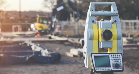 Close-up of surveyor optical equipment  tacheometer or theodolite on construction site with selective focus and blurred background toned image - obrazy, fototapety, plakaty