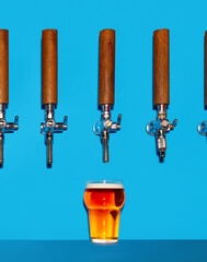 Dark beer pouring from tap into chilled glass. Beer forms thick, foaming as it cascades into mug.