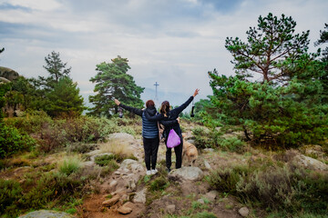 Adult women at the top of a viewpoint on the mountain