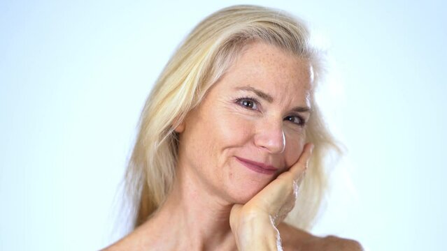 Closeup portrait of happy smiling attractive mature woman nude looking at camera. Advertising body care spa concept.