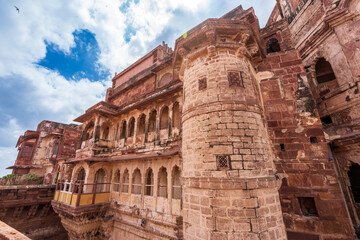 Look up at the red and yellow castle standing majestically on the hill. Mehrangarh Fort is in Jodhpur, Rajasthan, India. UNESCO World Heritage Site.