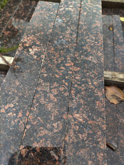 polished slabs of dark granite with red spots