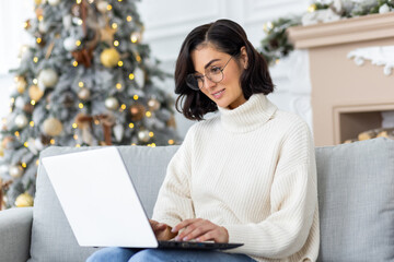 A young businesswoman, freelancer, student works and studies remotely from home during the winter...