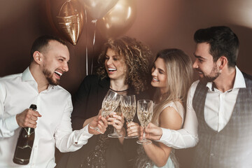 Group of elegantly dressed people celebrating a holiday or event, drinking sparkling wine