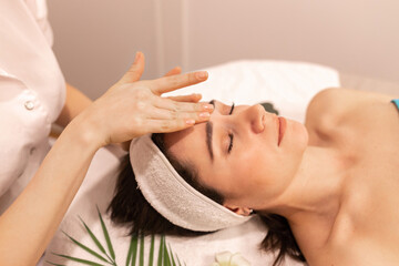 Obraz na płótnie Canvas Beautiful woman in spa salon getting face massage treatment. Girl facial treatment. Skin care. Body care.