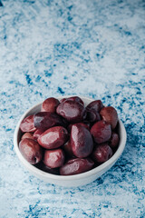 kalamata olives in a small ceramic bowl