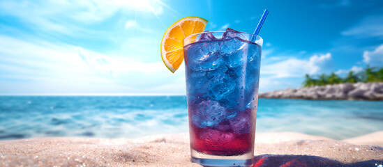 Blue Hawaii cocktail on a lagoon beach. A cocktail with lemon on the ocean beachfront. A beautiful glass with blue alcohol, a pipe and citrus in the sand. Blurred background of sea umbrellas & waves