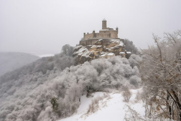 Forgotten medieval castle and small settlement and cold winter generative ai