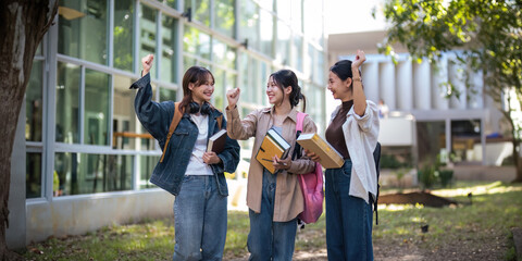 Fototapeta premium University student friendship concept with classmate friend walk together at campus college park. Youth teenage and education