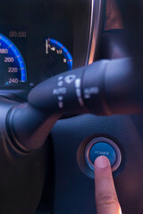 Finger pressing the car start button