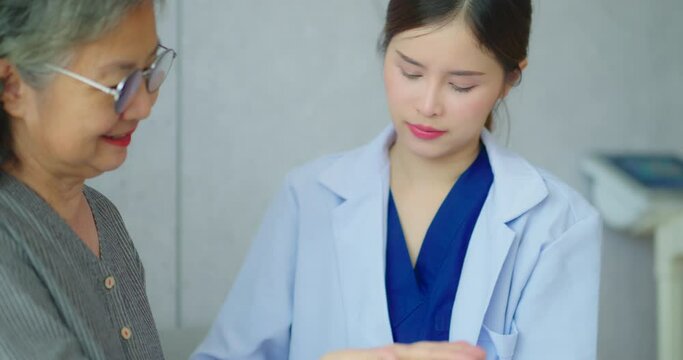 Senior woman talking with female nurse at hospital. Nurse makes an appointment with a senior woman at the hospital.