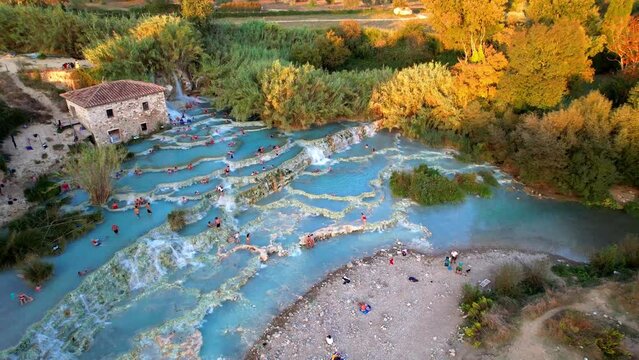 Most famous natural thermal hot spings pools in Tuscany - scenic Terme di Mulino vecchio ( Thermals of Old Windmill) in Grosseto province. Aerial drone 4K hd video 