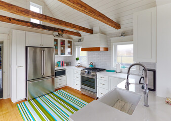 wood beam white washed kitchen in historic country seaside home in Nova Scotia