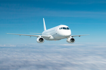 Obraz premium Modern white passenger airliner fly in the sky above the clouds