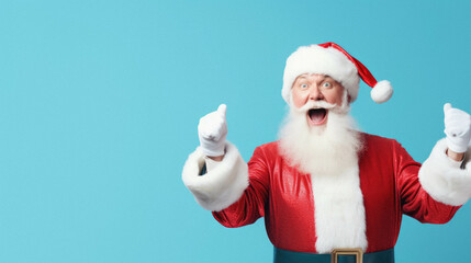Fototapeta na wymiar Santa claus pointing at blank thumbs up on blue studio background
