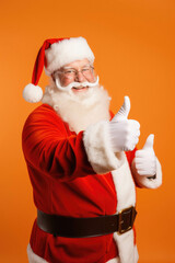 Fototapeta na wymiar Portrait of santa claus with thumb up showing thumb up on red background. happy new year and christmas
