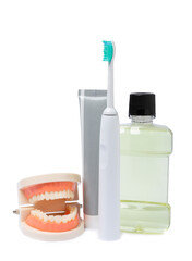 Electronic ultrasonic toothbrush, mouthwash, floss, tongue cleaner and toothpaste isolated on white...