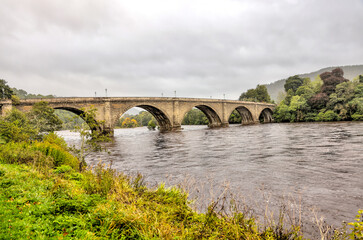 Fototapeta na wymiar Dunkeld, Scotland - September 25, 2023: The ancient bridge over the Tay River in Dunkeld, Scotland 