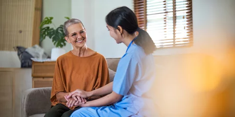 Fotobehang Empathy, trust and nurse caregiver holding hands with patient. consulting support and healthcare advice. Kindness, counseling and medical therapy in nursing home for hope, consultation and psychology © Natee Meepian