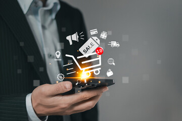 Online shopping. Man using smartphone with shopping cart icon on virtual screen for add products to cart and e-commerce technology concept.
