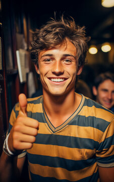 A soccer fan boy smiling with thumb up happy for him team won