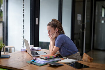 Businesswoman sitting in the office is stressed, working hard, feeling stressed and dizzy from...