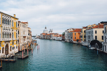 Fototapeta na wymiar Famous view of Venice Grand Canal with Saint Mary of Health dome on sunny day from Ponte dell'Accademia bridge. Italian travel destination and landmark, tourist attraction.
