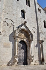 Romanesque church in Bari, church with the tomb of Queen Bona Sforza, large gates to the church, decorations on the church building, Italian Romanesque church