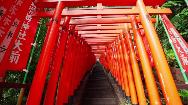 Tokyo, Japan, October 10, 2023 : Red flags banners called nobori and Row of Gates Torii path in Hie Shinto shrine in Minato, Tokto, Japan. Hie shrine gate entrance